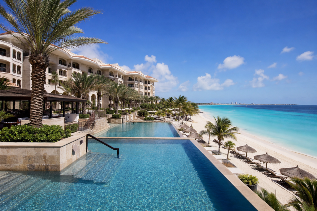 Where to Stay in Aruba in 2026: Best Areas & Hotels for Every Traveler 2 Luxury beachfront resort on Palm Beach Aruba with infinity pool and turquoise sea
