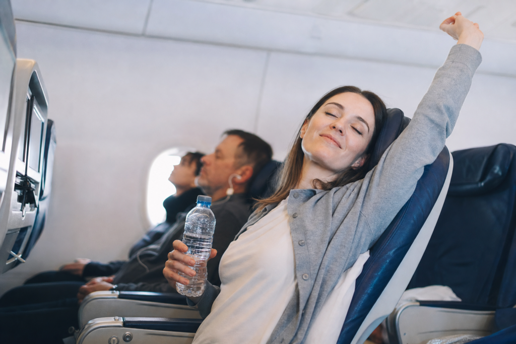 Essential Holiday Travel Tips for 2026: Your Stress-Free Guide to the Festive Season 16 Passenger hydrated on long flight